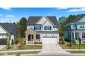 Charming two-story home featuring a brick entryway, white siding, and a well-maintained lawn at 1724 Deacon Falls Way, Wendell, NC 27591