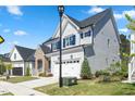 Side view of a well-maintained two-story home with white siding and a manicured lawn at 1724 Deacon Falls Way, Wendell, NC 27591