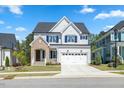 Attractive two-story home with white siding, blue shutters, and a manicured front yard at 1724 Deacon Falls Way, Wendell, NC 27591