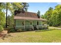 Attractive home with a welcoming front porch, detailed latticework, and well-maintained yard at 209 Pen Lou Ct, Angier, NC 27501