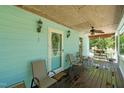 Relaxing covered porch with wood flooring, ceiling fan, and ample seating at 209 Pen Lou Ct, Angier, NC 27501