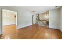 Spacious living room showcasing hardwood floors, neutral walls, and stairs leading to the second floor at 2211 Hillock Dr, Raleigh, NC 27612