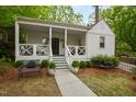 Inviting front porch with cozy seating and decorative plants, offering a relaxing outdoor space at 2415 Van Dyke Ave, Raleigh, NC 27607