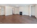 Spacious living room with a cozy fireplace, hardwood floors, and plenty of natural light at 2434 Heron Watch Pl, Fuquay Varina, NC 27526