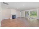 Bright living room featuring a fireplace and sliding glass doors leading to an outdoor area at 2434 Heron Watch Pl, Fuquay Varina, NC 27526