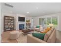 Bright living room with fireplace, hardwood floors, and sliding glass doors to the outdoor living space at 2434 Heron Watch Pl, Fuquay Varina, NC 27526