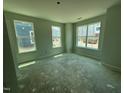 Spacious bedroom featuring three large windows providing natural light and views of the surrounding neighborhood at 311 Chesapeake Commons St # 101, Garner, NC 27529