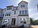 Modern new construction townhome boasting many windows, offering ample natural light throughout the living space at 311 Chesapeake Commons St # 101, Garner, NC 27529