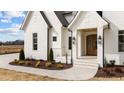 Close up of a house's entrance, featuring beautiful landscaping and an elegant front door at 3941 Wendell Blvd, Wendell, NC 27591