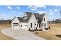 Beautiful exterior showcasing a well-manicured lawn, attached garage, and a stylish front entrance at 3941 Wendell Blvd, Wendell, NC 27591