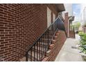 Brick townhome entrance stairs with black metal railing at 400 W Rosemary St # 104, Chapel Hill, NC 27516