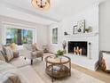 Bright living room with a white brick fireplace and large windows overlooking the yard at 403 Mayodan Dr, Cary, NC 27511