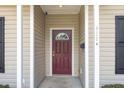 Inviting front door with glass detail framed by white columns and a well-lit entry way at 411 B Aversboro Rd, Garner, NC 27529