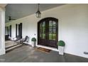 Charming front porch with cozy seating, a wood-stained ceiling, and elegant double doors at 4237 Rowan St, Raleigh, NC 27609