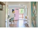 Light-filled entryway with a charming pink front door and stylish decor at 4513 Denfield St, Durham, NC 27704