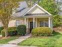 Charming home with a covered front porch, tidy landscaping, and neutral siding at 522 Auburn Square Dr, Durham, NC 27713