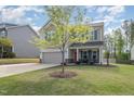 Traditional two-story home featuring a well-manicured lawn and a charming covered entryway at 528 Holden Forest Dr, Youngsville, NC 27596