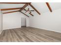 Large living room with exposed beams, hard wood floors and large windows at 5604 Groomsbridge Ct, Raleigh, NC 27612