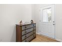 Charming entryway featuring a decorative chest and a glass-paneled front door at 61 Okra Ct, Selma, NC 27576
