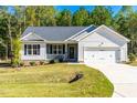 Inviting one-story home with a manicured lawn and an attached two-car garage at 61 Okra Ct, Selma, NC 27576
