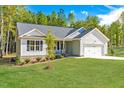 Beautiful single-story home with a large front yard and attached two-car garage at 61 Okra Ct, Selma, NC 27576