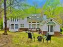Inviting backyard featuring an outdoor fireplace with seating, and a well-manicured lawn at 6212 Trevor Ct, Raleigh, NC 27613