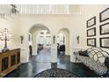 Elegant foyer with archways, chandelier, and black-and-white patterned bench seating at 6212 Trevor Ct, Raleigh, NC 27613