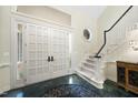 Grand foyer with a staircase, chandelier, high ceilings, and decorative tile flooring at 6212 Trevor Ct, Raleigh, NC 27613