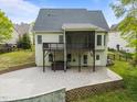 Spacious backyard with paver patio, screened porch, and lush greenery, creating an ideal space for entertaining at 733 Holding Ridge Ct, Wake Forest, NC 27587