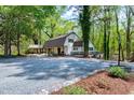 This house features a spacious driveway, mature trees, and a welcoming exterior at 831 Healey Ln, Durham, NC 27705