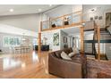 Open-concept living room showcasing hardwood floors, natural light, and a loft overlooking the space at 831 Healey Ln, Durham, NC 27705