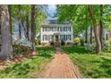 Charming two-story home with black shutters and a brick walkway leading to the front door at 8805 Mourning Dove Rd, Raleigh, NC 27615