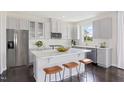 Modern kitchen with white cabinets, stainless steel appliances, and a spacious center island at 900 Emmer St, Rolesville, NC 27571