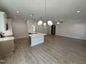 This kitchen has an open design, white cabinets, recessed lighting, stainless appliances and a center island at 1008 Peedin Rd, Selma, NC 27576