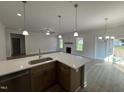 Modern kitchen island with sink and stainless appliances in open-concept design at 1008 Peedin Rd, Selma, NC 27576