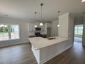 Modern kitchen with a large island, white cabinets, and stainless steel appliances at 1008 Peedin Rd, Selma, NC 27576