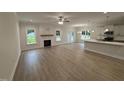 Open-concept living room boasts hardwood floors, a fireplace, recessed lighting and a ceiling fan at 1008 Peedin Rd, Selma, NC 27576
