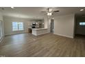 Sunlit living room features hardwood floors, recessed lighting and open view to kitchen at 1008 Peedin Rd, Selma, NC 27576