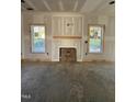 Living room featuring a decorative fireplace and large windows for natural lighting at 1008 Peedin Rd, Selma, NC 27576