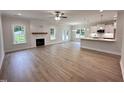 Bright living room with wood floors, a fireplace, open to the kitchen, and with lots of natural light at 1008 Peedin Rd, Selma, NC 27576