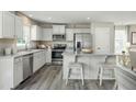 Stylish kitchen features modern appliances, granite countertops, and an island with seating at 11 Artesa Ct, Fuquay Varina, NC 27526