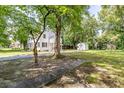 Spacious backyard featuring mature trees, a shed, and a driveway to the back of the house at 1106 Sycamore St, Rocky Mount, NC 27801
