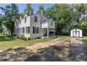 Back of house featuring a white brick exterior, a covered porch, and a shed at 1106 Sycamore St, Rocky Mount, NC 27801