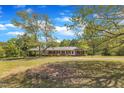 Charming brick home with a covered carport and mature trees at 1213 Walnut St, Cary, NC 27511