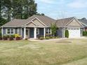 Charming single Gathering home with two-car garage and landscaped front yard at 125 Claymore Dr, Clayton, NC 27527