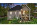 Rear exterior view with a raised wooden deck and fenced yard at 128 Waterleaf Pl, Clayton, NC 27527