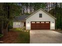 A beautiful exterior shot of a house with a garage and driveway taken during dusk at 1368 Ohio Ln, Sanford, NC 27332