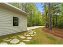 A view of the property showing the driveway and stone path leading to the road at 1368 Ohio Ln, Sanford, NC 27332