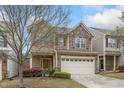 Charming two-story home with a two car garage, stone accents, and manicured lawn at 140 Torrey Heights Ln, Durham, NC 27703