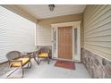 Inviting front porch with seating area and stylish front door at 140 Torrey Heights Ln, Durham, NC 27703